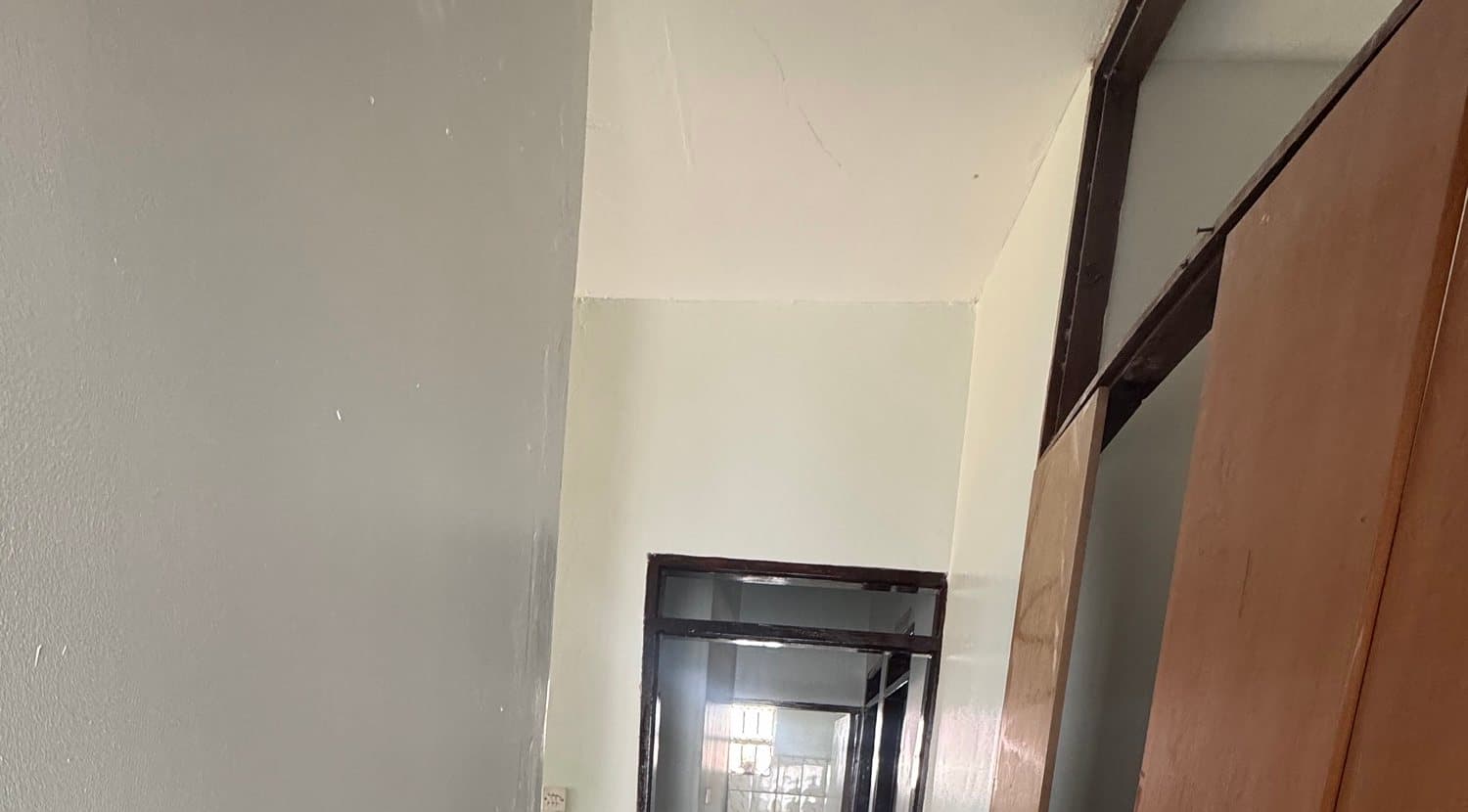 The upper walls and a doorway of the corridor at Shalom Clinic after repainting