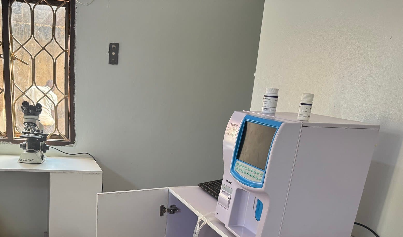 Our lab at Shalom Clinic, with the microscope by the window and the blood testing machine